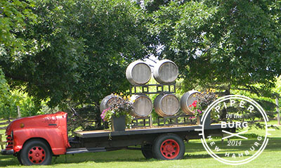 Old flatbed truck with wine barrels loaded on the back